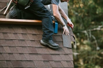 man working on roof