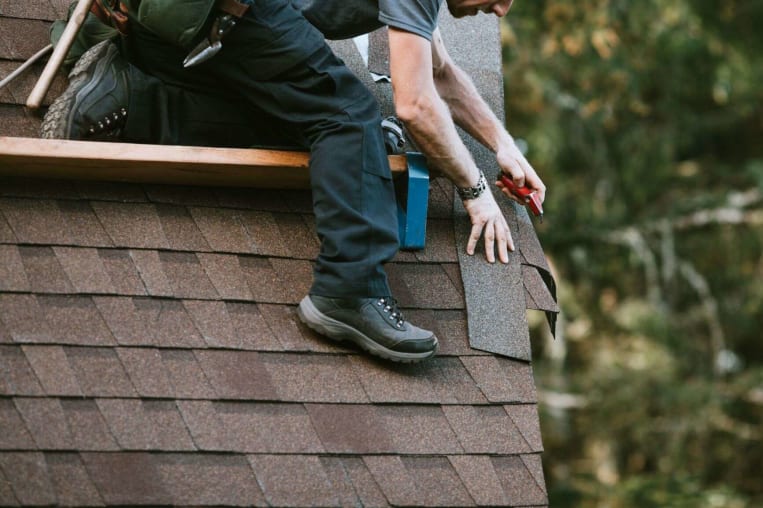 man working on roof