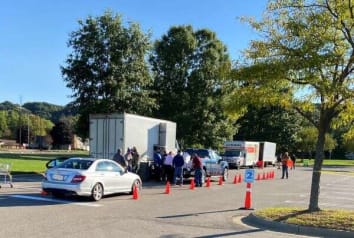 Cars lined up next to shred truck to drop off documents to be shred